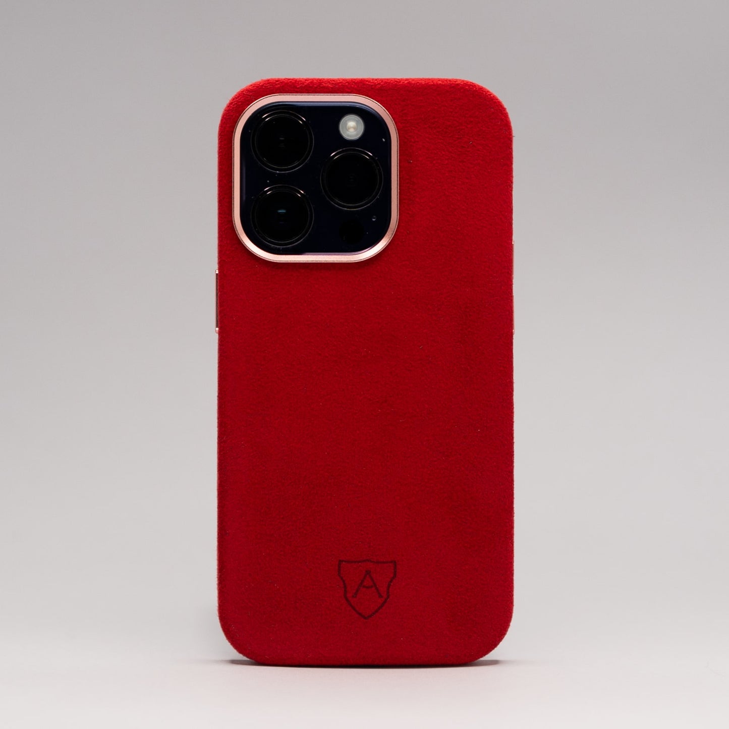 A premium red Alcantara iPhone case with a camera cutout and metal buttons, featuring a sleek and luxurious design.
